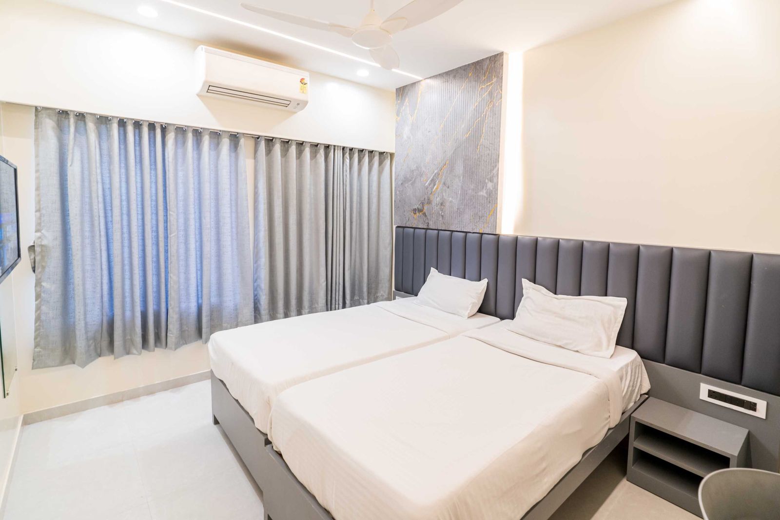 Cedar Deluxe — queen room with garden-facing window — Lake Bloom Residency Powai