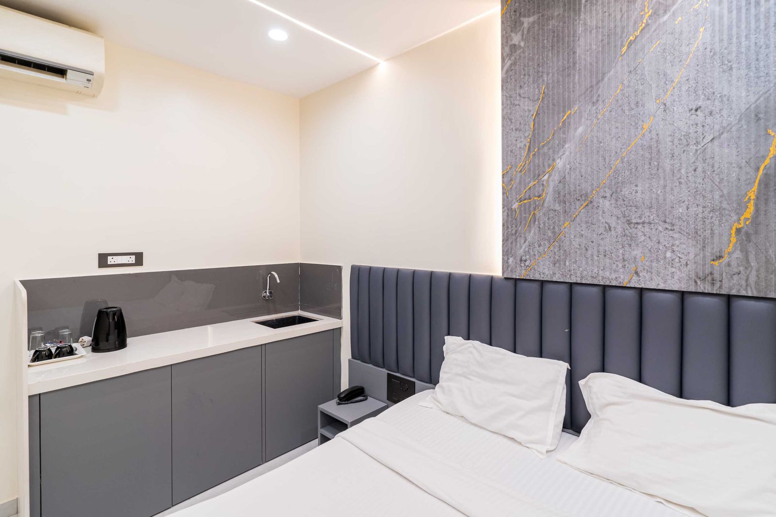 Teak Studio — kitchenette and bed — Lake Bloom Residency Powai