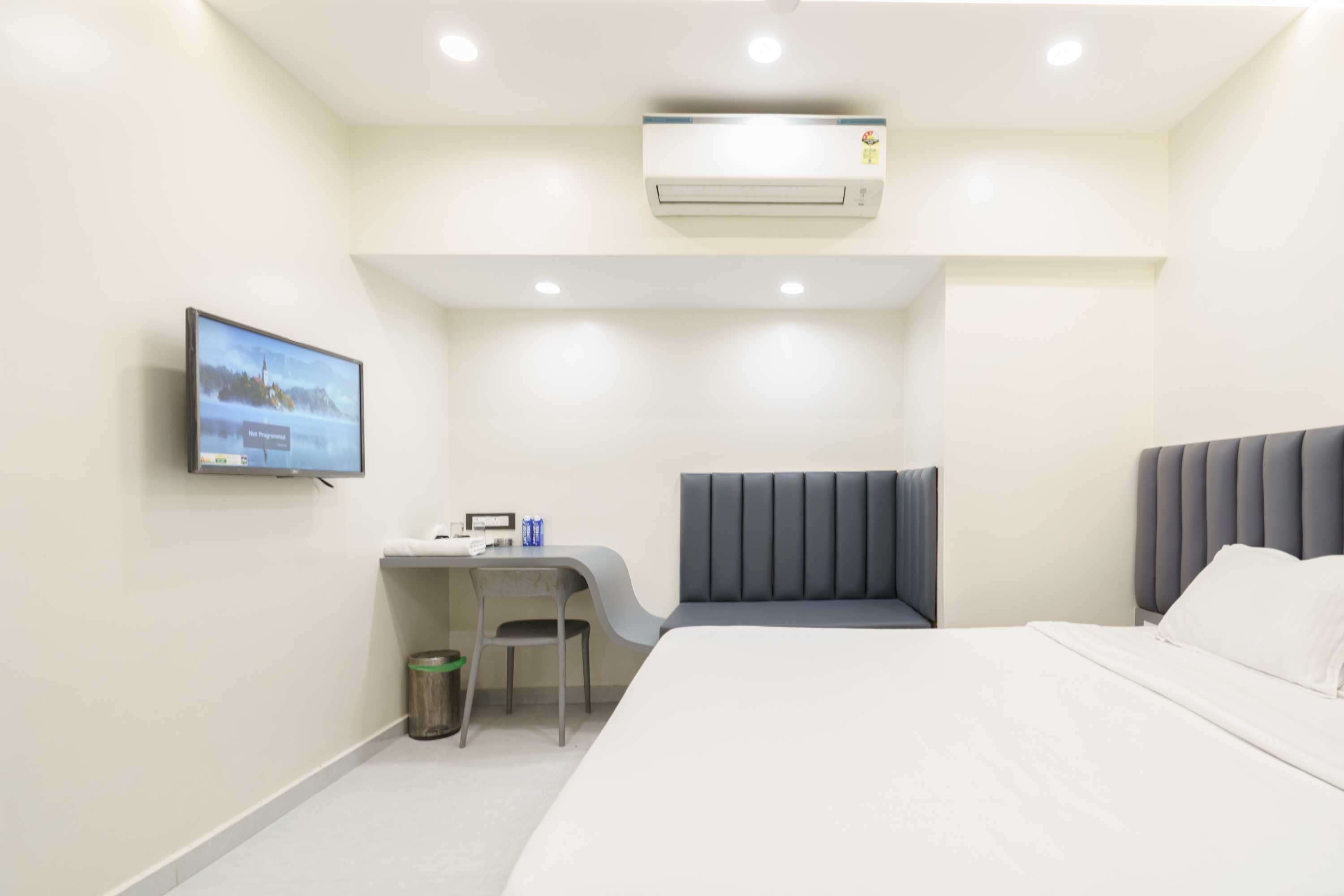 Cedar Deluxe room at Lake Bloom Residency Powai — queen bed with premium linen